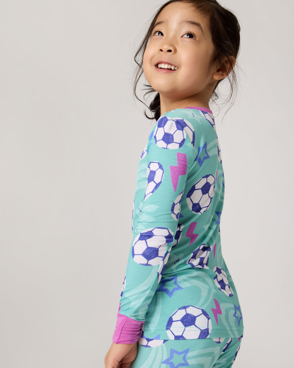 Close up of child wearing the Aqua Soccer Stars Two-Piece Pajama Set