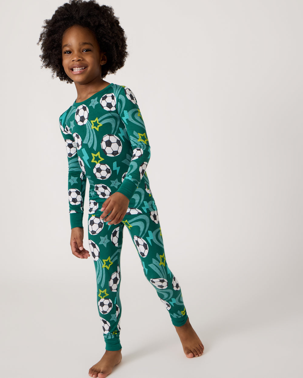 Standing boy wearing the Soccer Stars Two-Piece Pajama Set