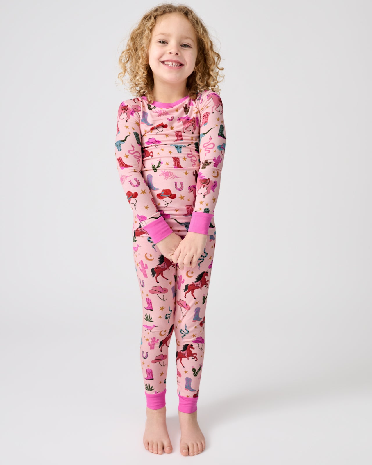 Child wearing the Pink Rancher Roundup Two-Piece Pajama Set