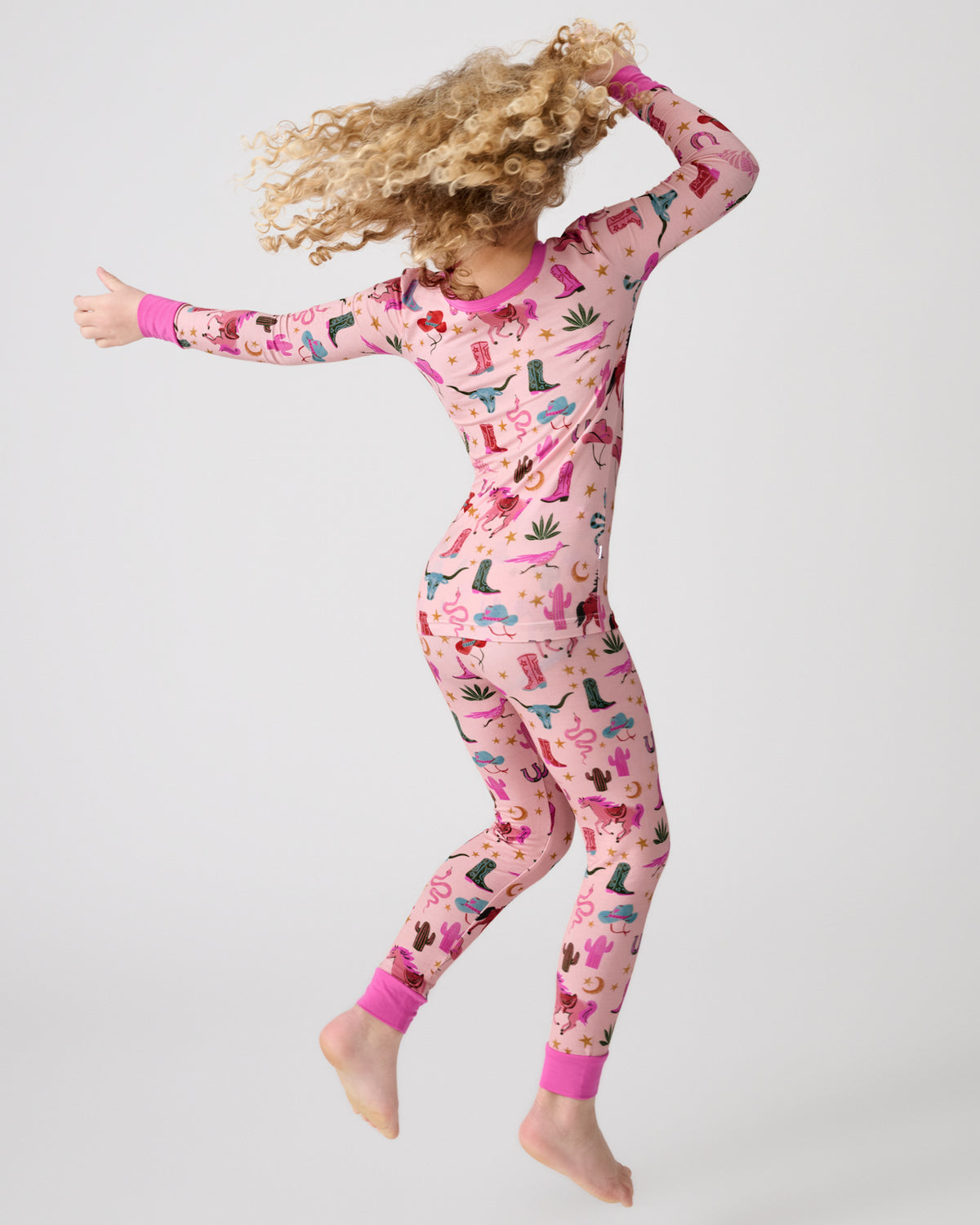 Dancing child wearing the Pink Rancher Roundup Two-Piece Pajama Set