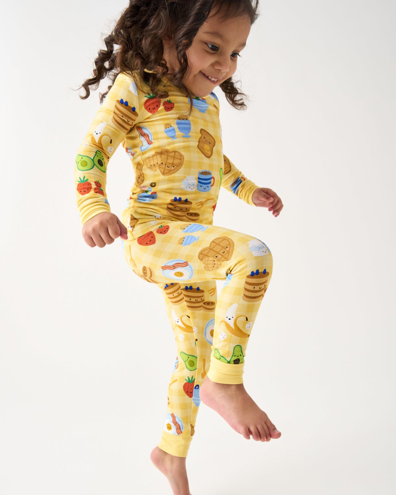 Child in motion wearing the Breakfast Bunch Two-Piece Pajama Set