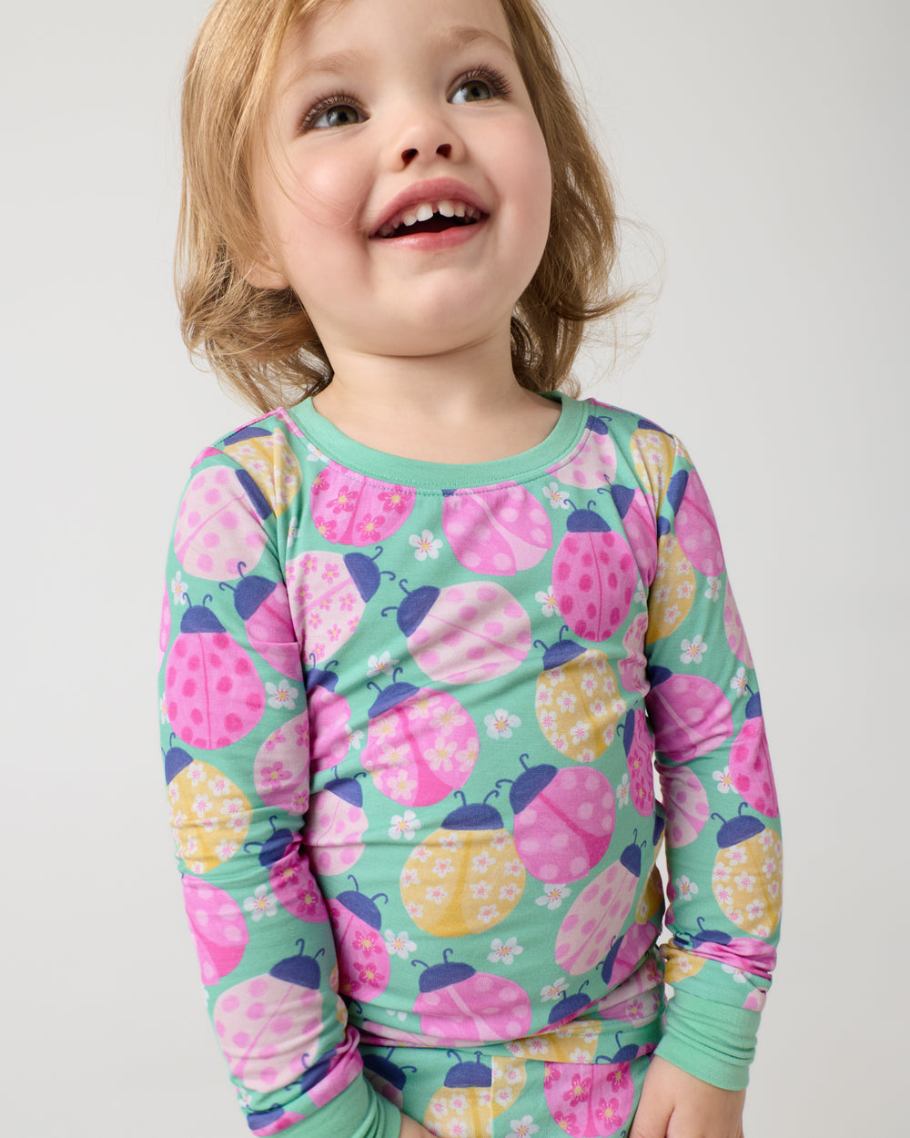Close up of girl wearing the Ladybug Meadow Two-Piece Pajama Set