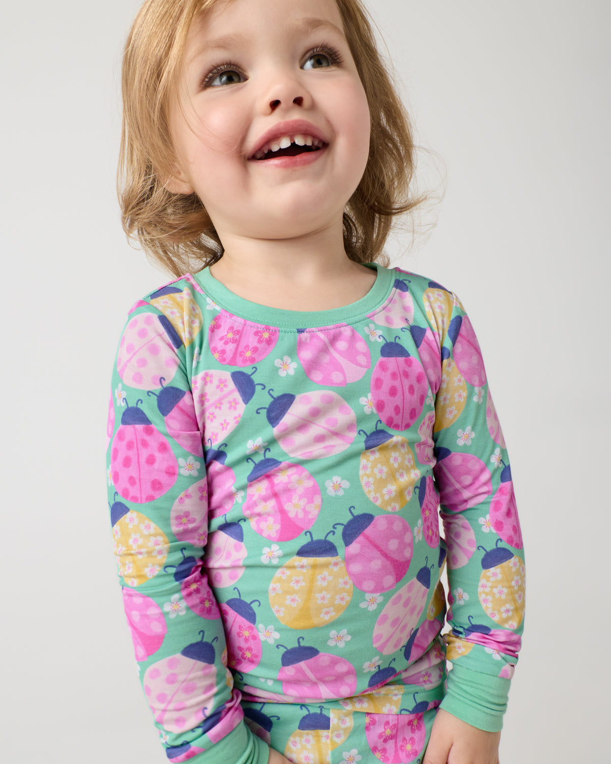 Close up of girl wearing the Ladybug Meadow Two-Piece Pajama Set