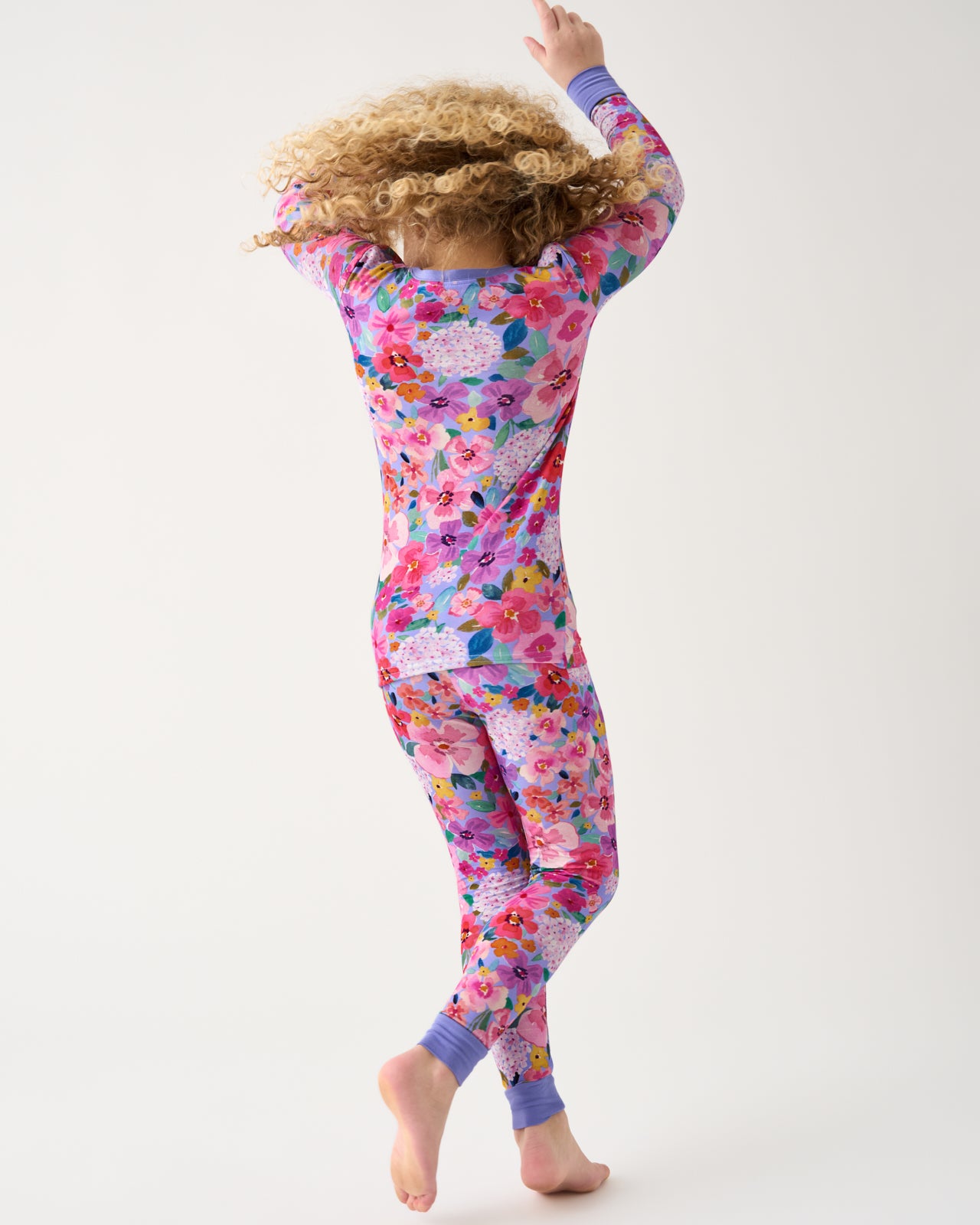 Girl in motion wearing the Sweet Sprigs Two-Piece Pajama Set