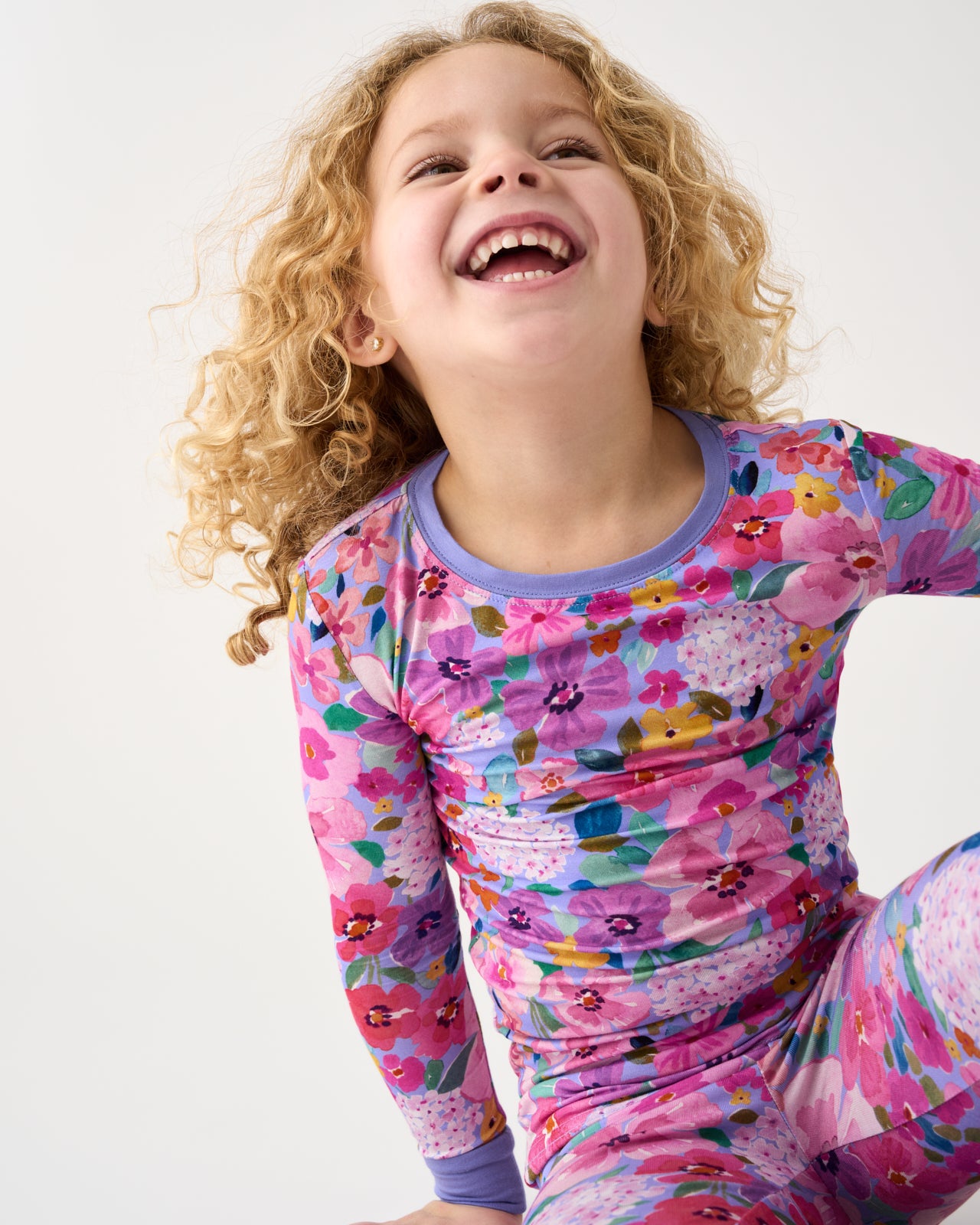 Sitting girl wearing the Sweet Sprigs Two-Piece Pajama Set