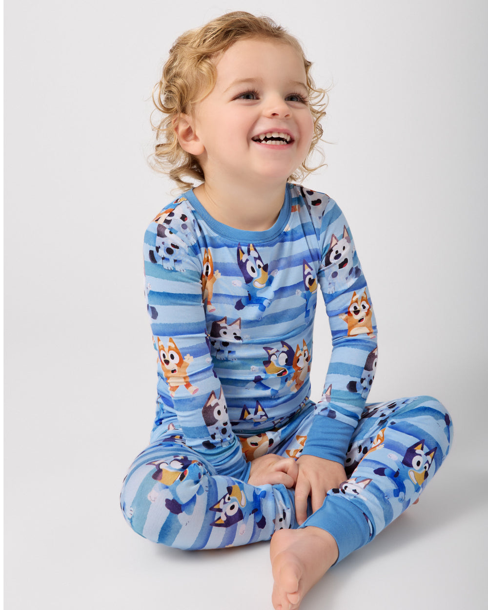 Sitting child wearing the Bluey Dance All Day Two-Piece Pajama Set