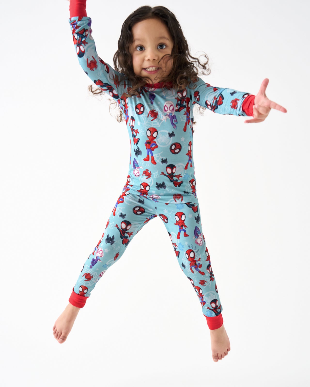 Jumping girl wearing the Spidey & Friends Tiny Webs Two-Piece Pajama Set
