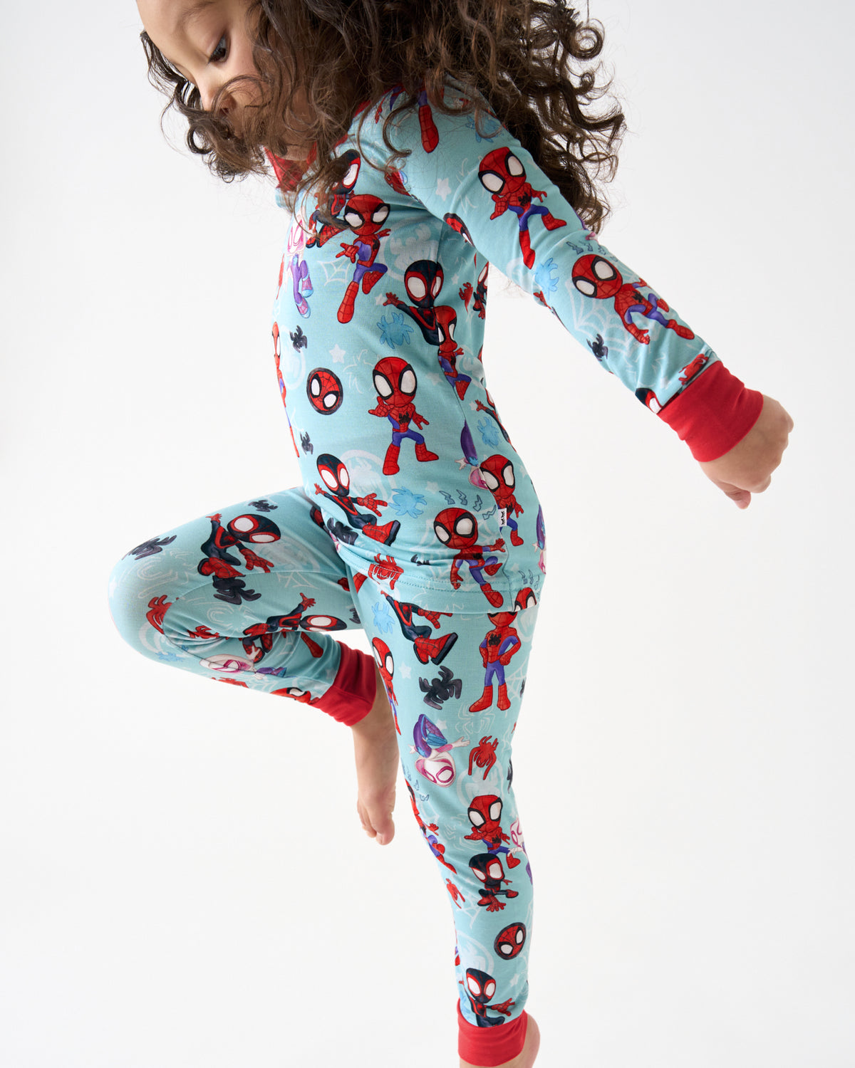 Child in motion wearing the Spidey & Friends Tiny Webs Two-Piece Pajama Set