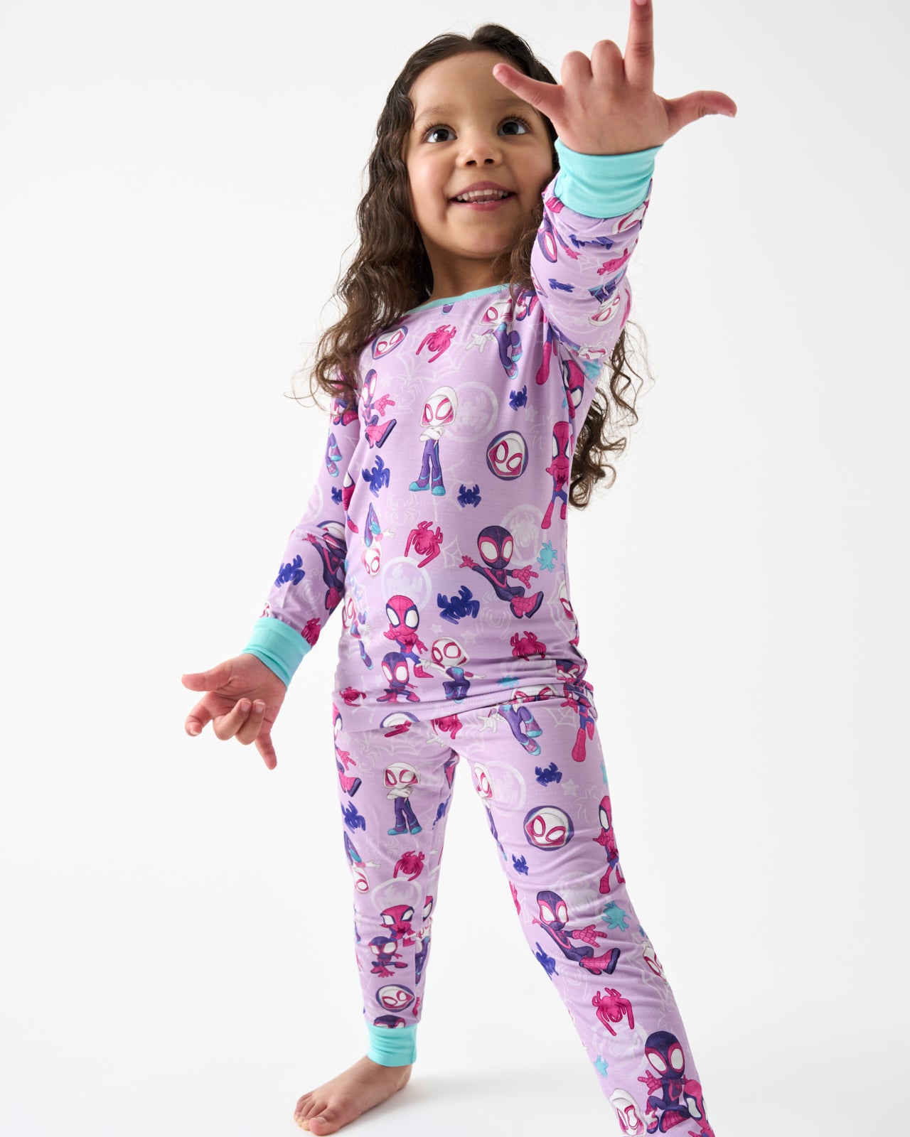 Posing girl wearing the Spidey & Friends Tiny Webs Two-Piece Pajama Set
