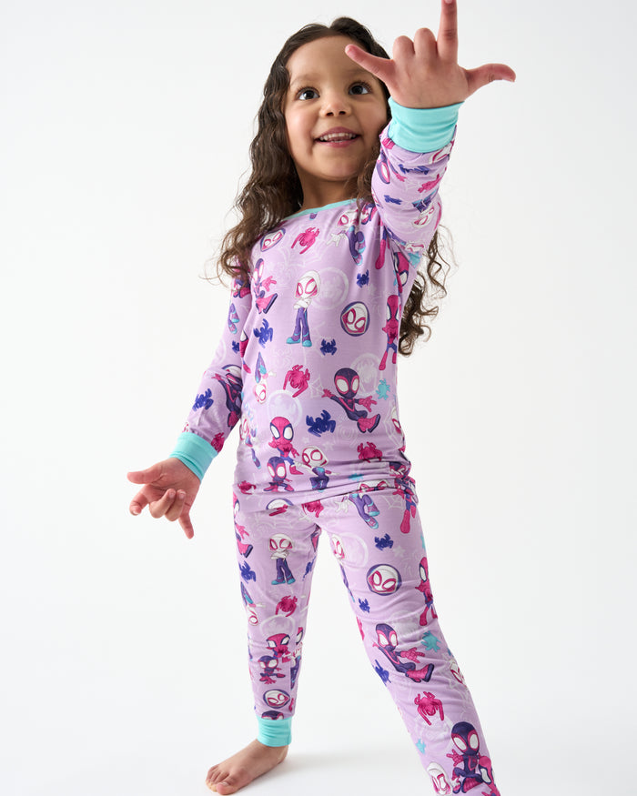 Posing girl wearing the Spidey & Friends Tiny Webs Two-Piece Pajama Set