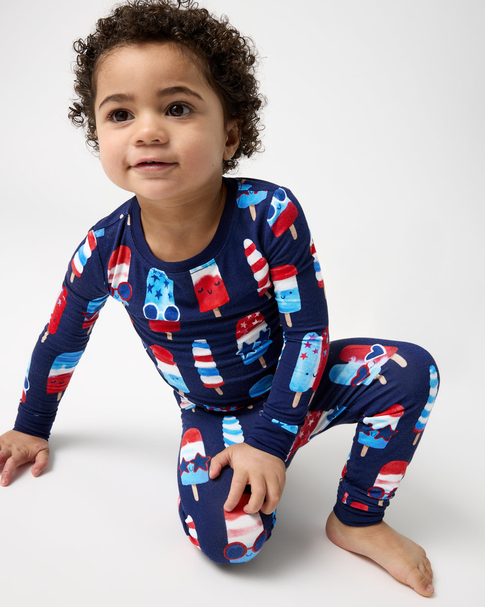 Crouching boy wearing the Sparkle Treats Two-Piece Pajama Set