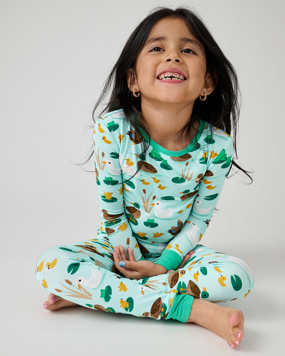 Sitting girl wearing the Puddle Jumpers Two-Piece Pajama Set