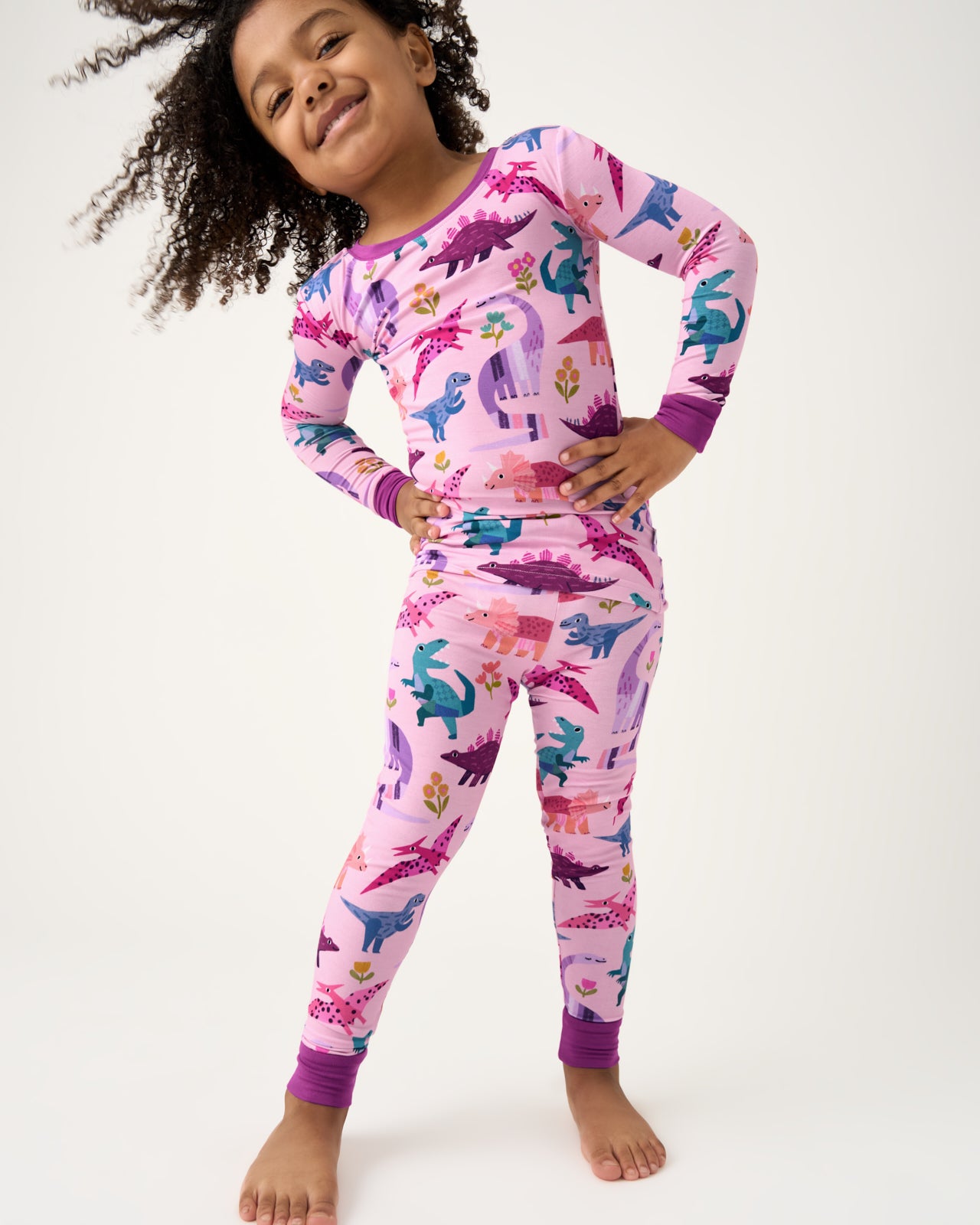 Standing girl wearing the Pink Roar & Explore Two-Piece Pajama Set