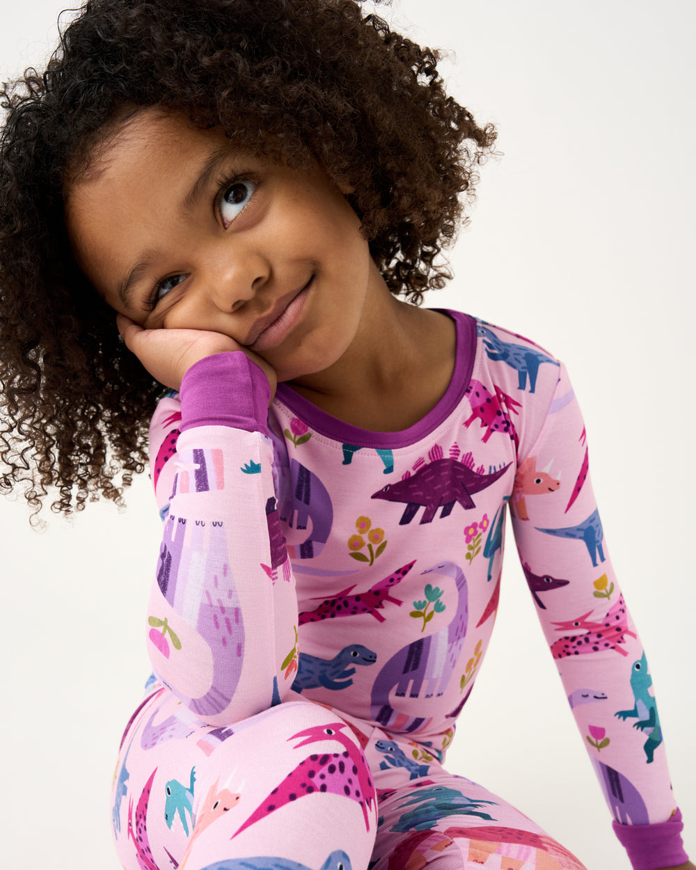 Close up of girl wearing the Pink Roar & Explore Two-Piece Pajama Set
