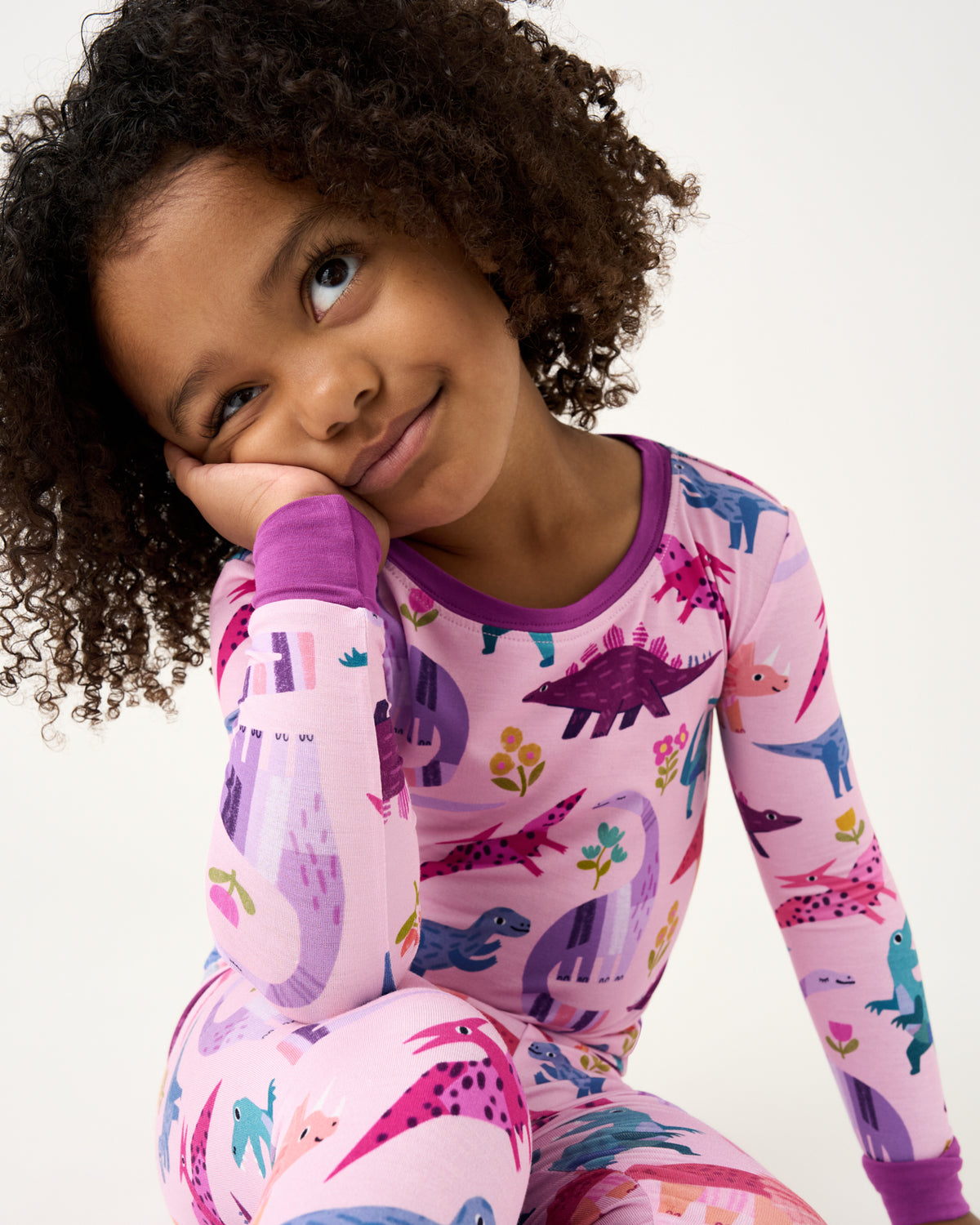 Close up of girl wearing the Pink Roar & Explore Two-Piece Pajama Set