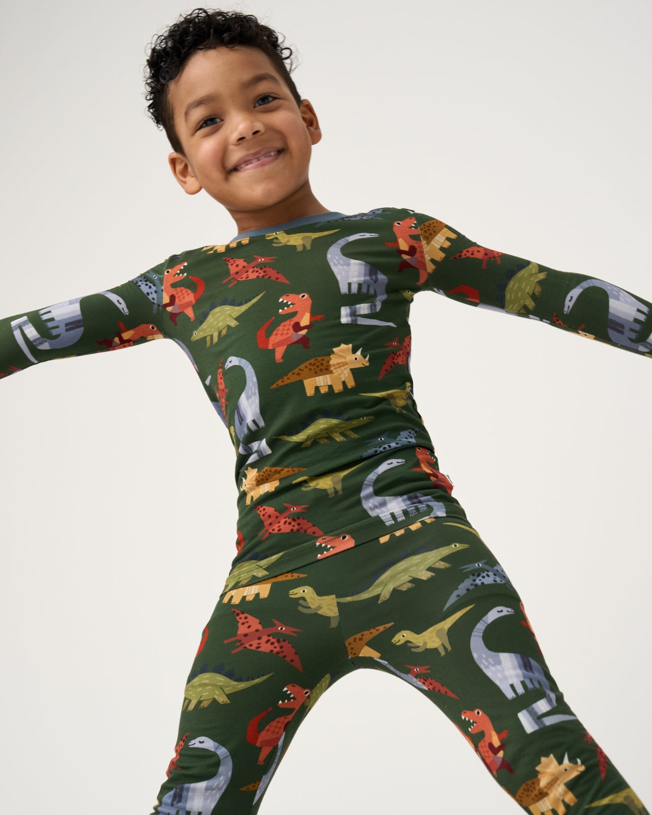 Close up of boy wearing the Green Roar & Explore Two-Piece Pajama Set