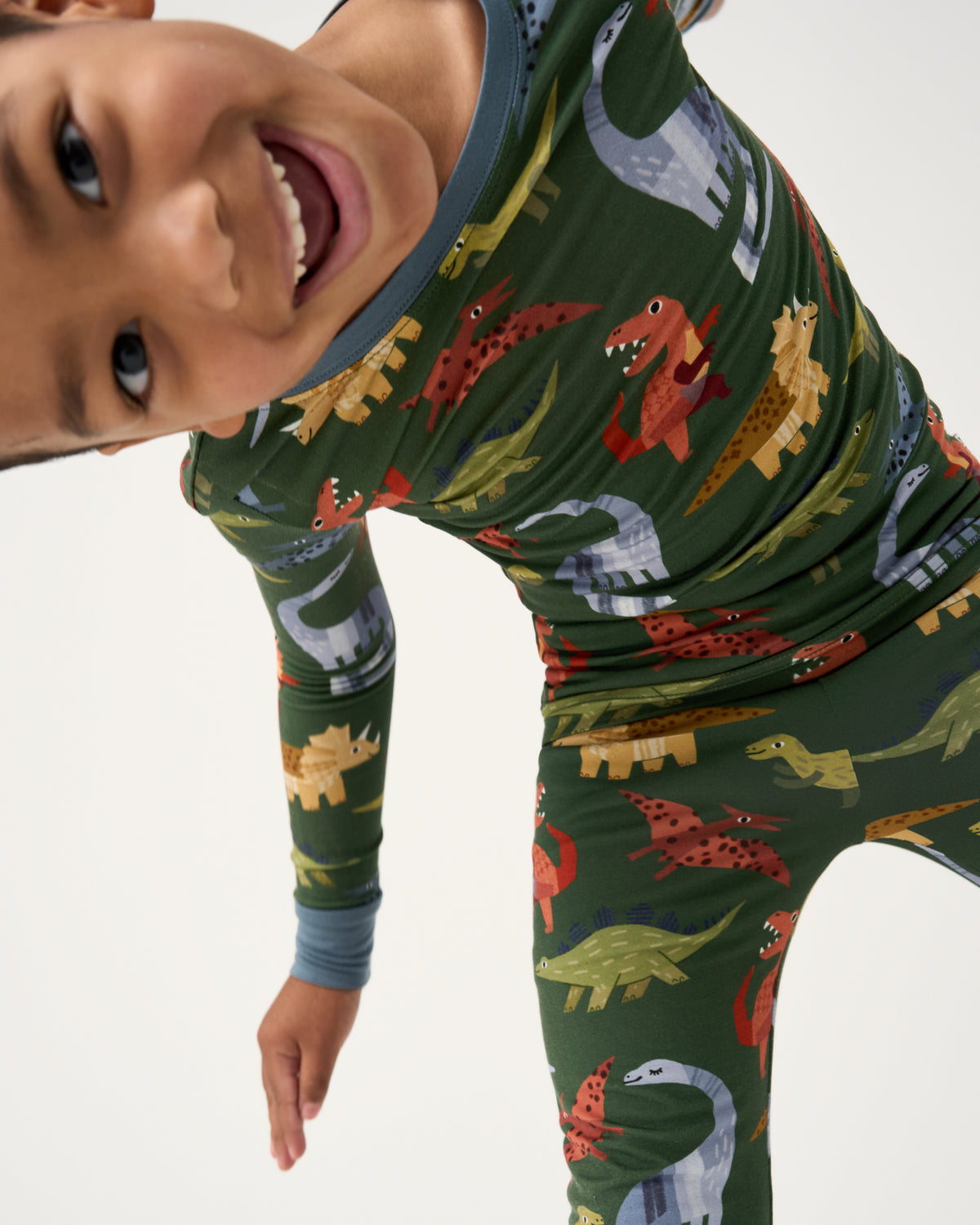 Close up of child wearing the Green Roar & Explore Two-Piece Long Sleeve Pajama Set