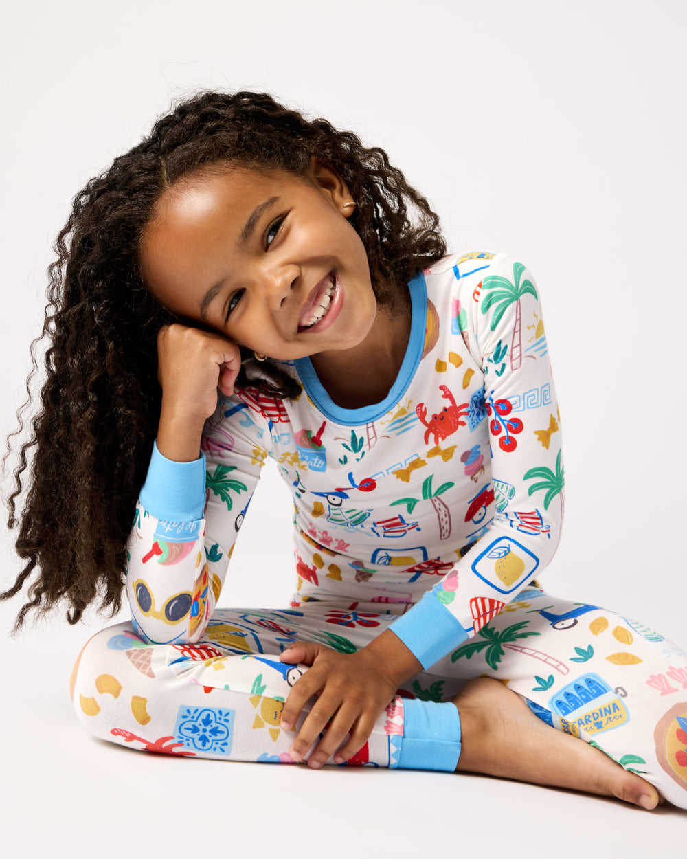 Sitting girl wearing the Ciao Bella Two-Piece Pajama Set