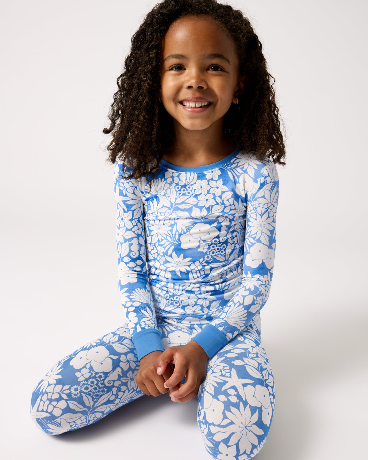 Girl wearing the Azure Garden Two-Piece Pajama Set on a white back drop