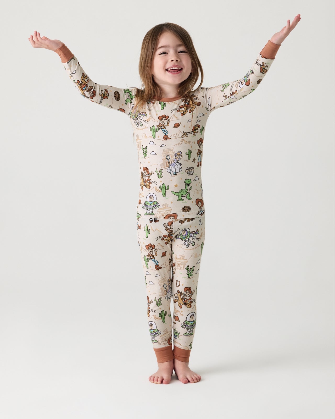 Standing girl wearingthe Disney & Pixar Woody's Wild West Two-Piece Pajama Set