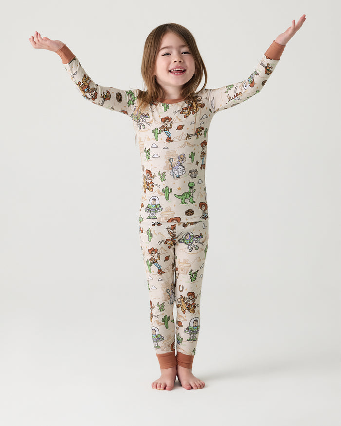 Standing girl wearingthe Disney & Pixar Woody's Wild West Two-Piece Pajama Set