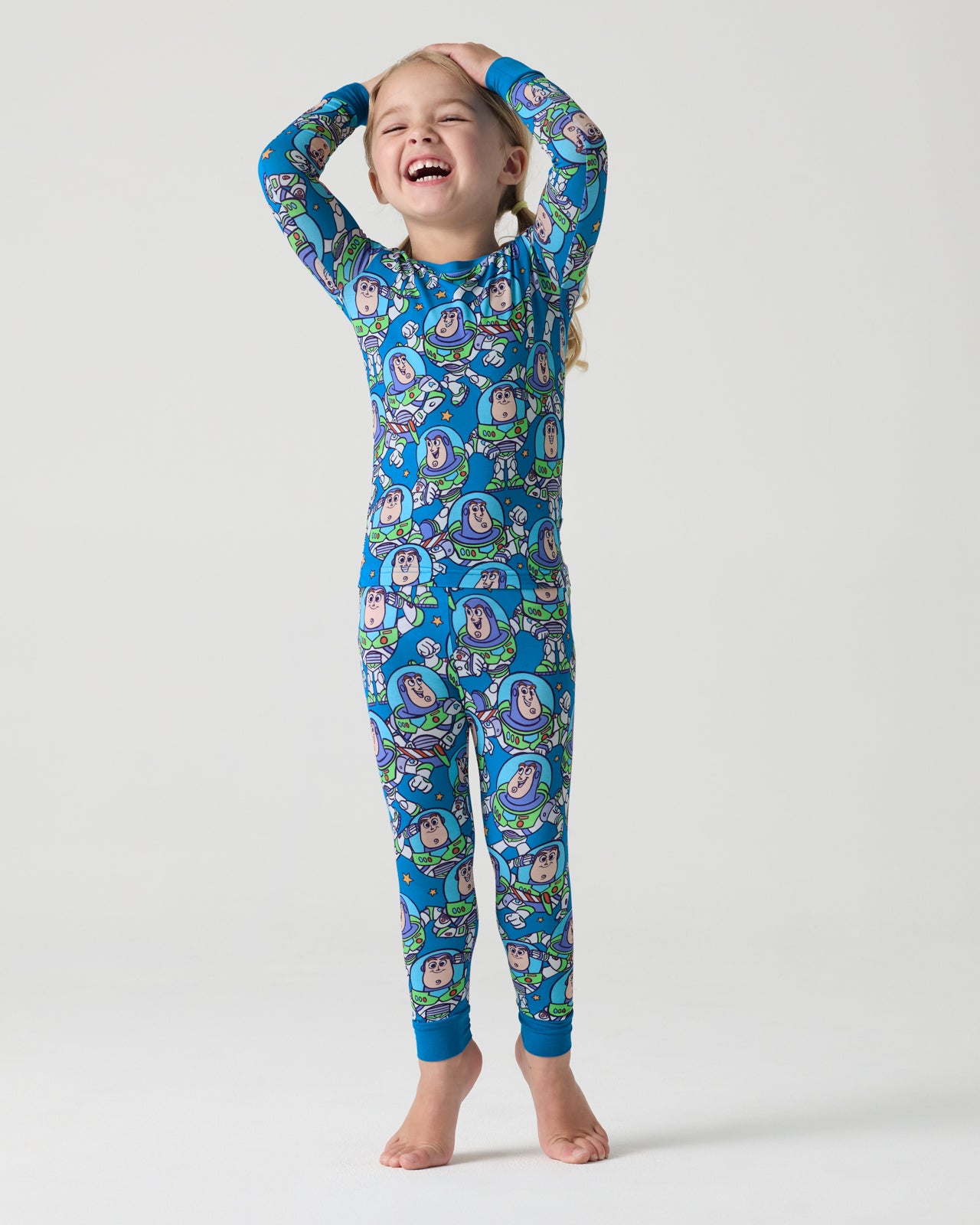Standing girl wearing the Disney & Pixar Buzz's Cosmic Crew Two-Piece Pajama Set
