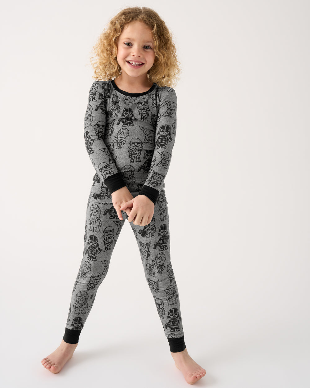 Standing girl wearing the Star Wars Far, Far, Away Friends Two-Piece Pajama Set