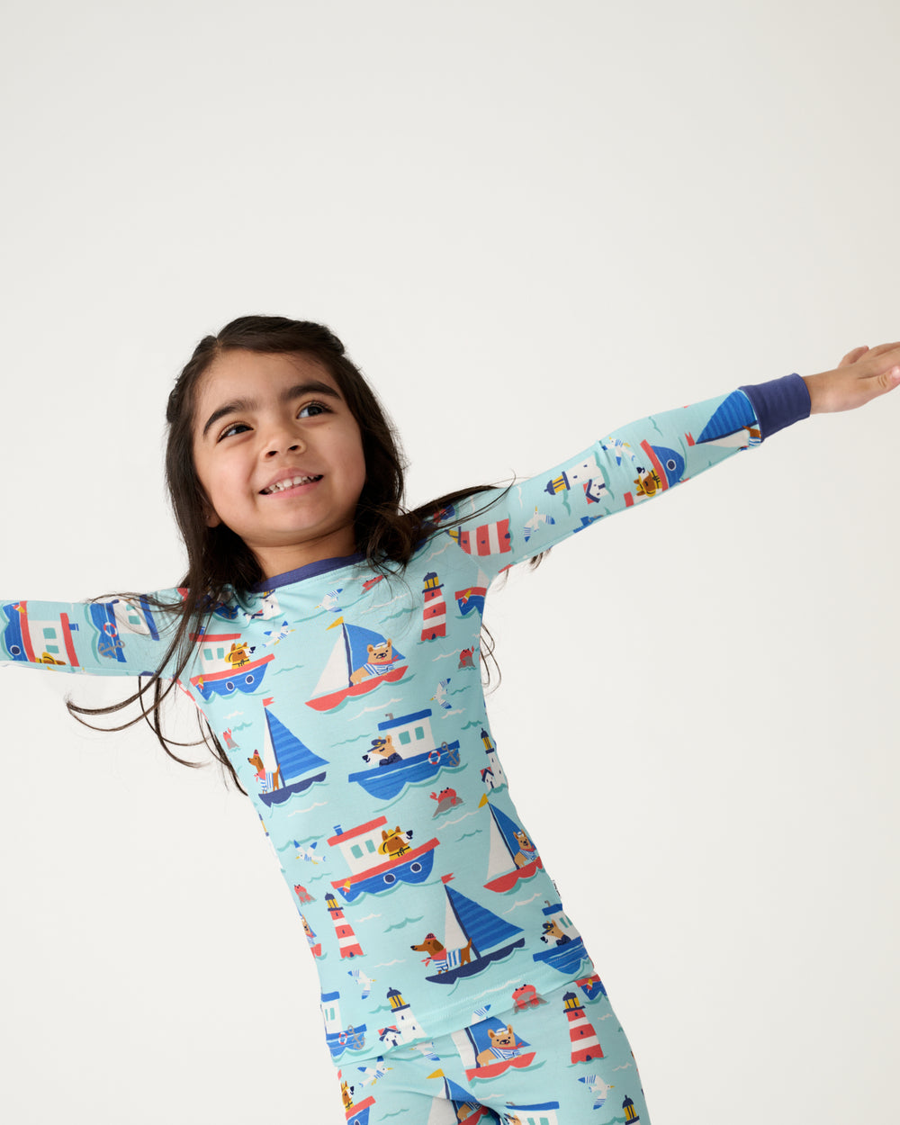 Close up of girl wearing the Nautical Paws Two-Piece Pajama Set
