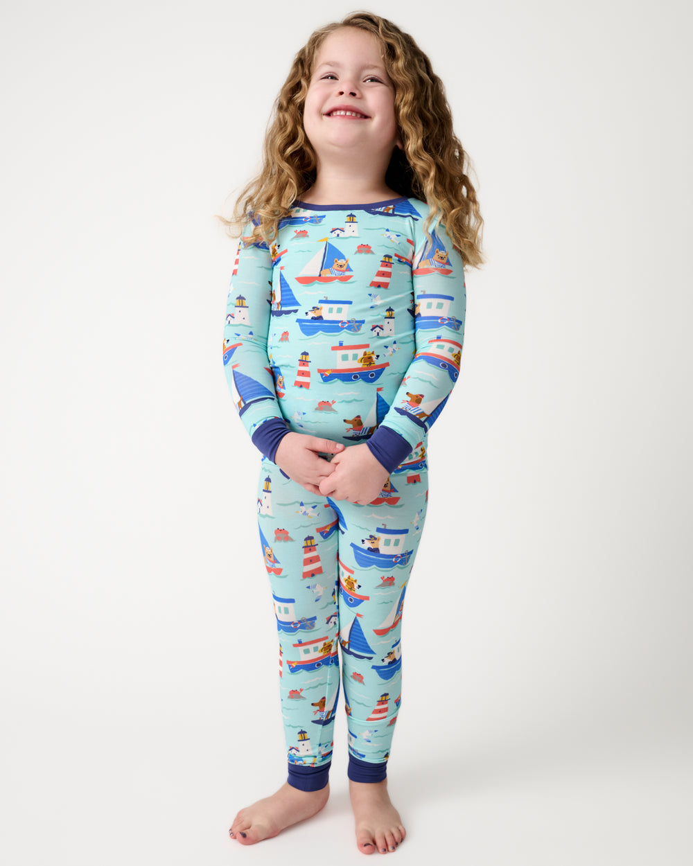 Standing child wearing the Nautical Paws Two-Piece Pajama Set