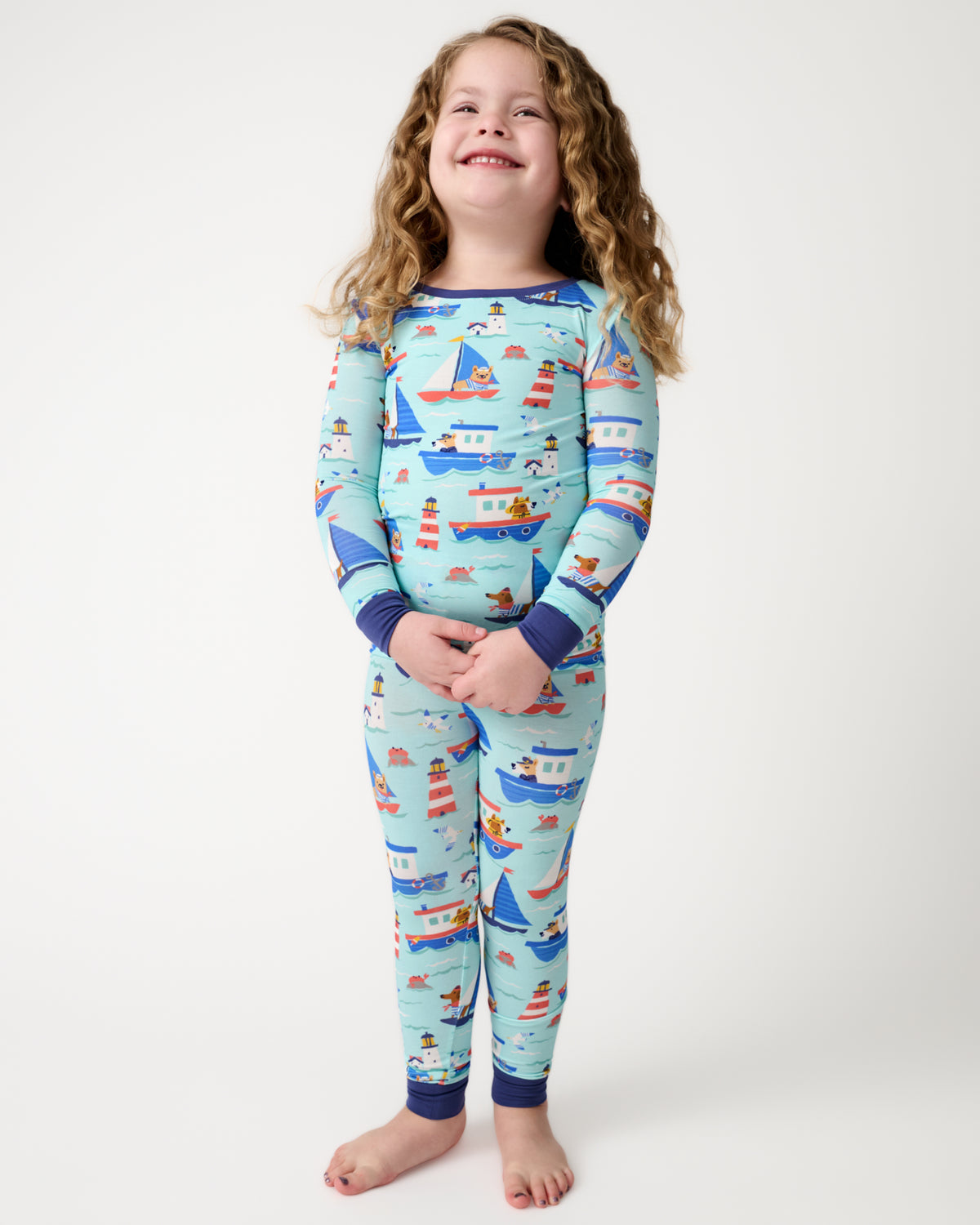 Standing child wearing the Nautical Paws Two-Piece Pajama Set