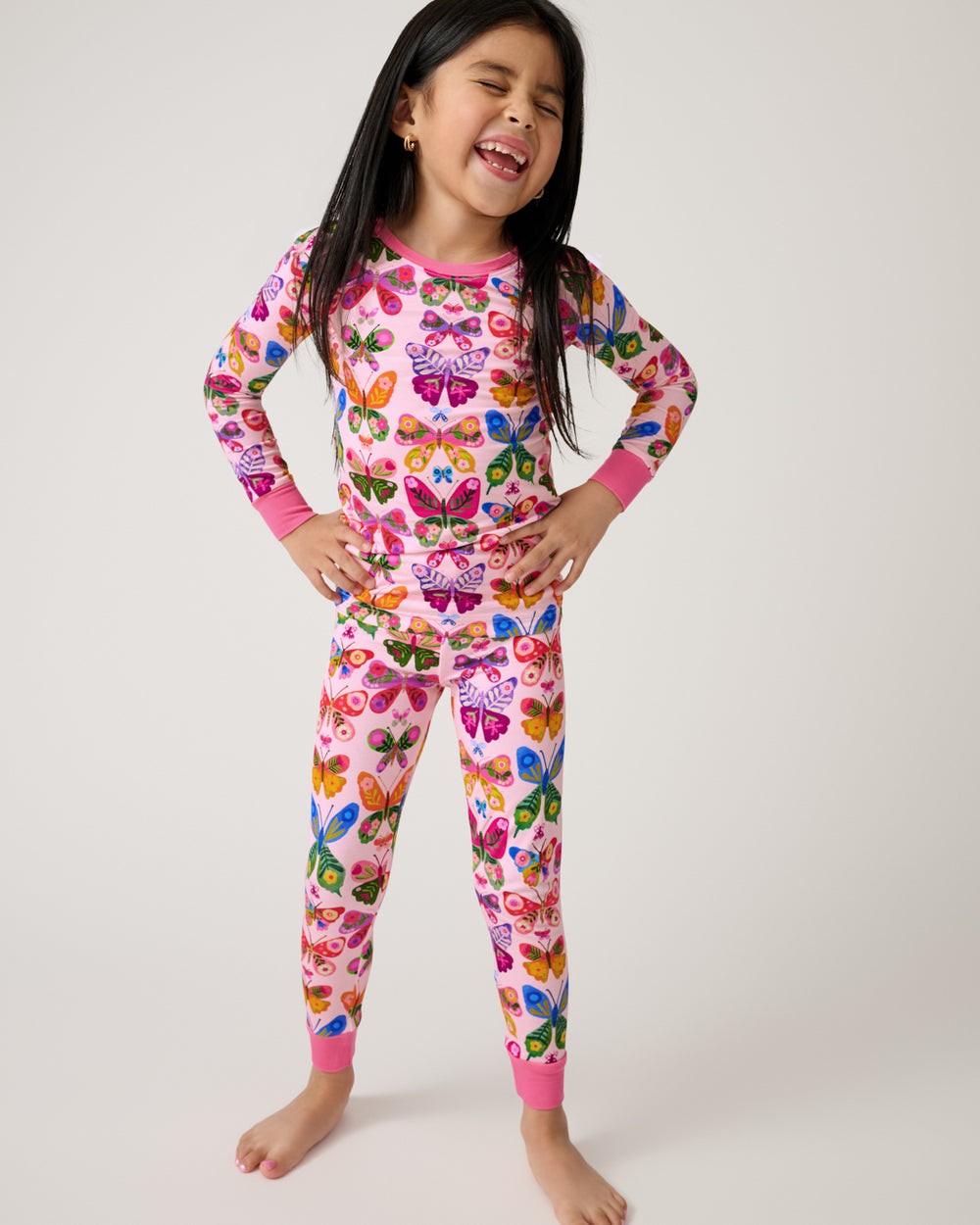 Standing girl wearing the Flutter Garden Two-Piece Pajama Set