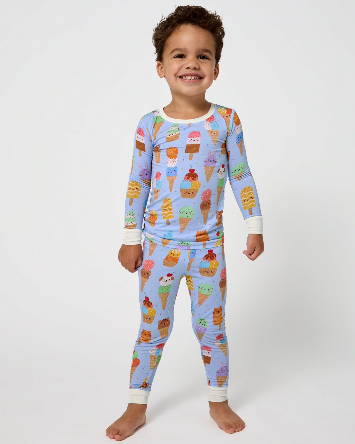 Standing boy wearing the Scoop Squad Two-Piece Pajama Set