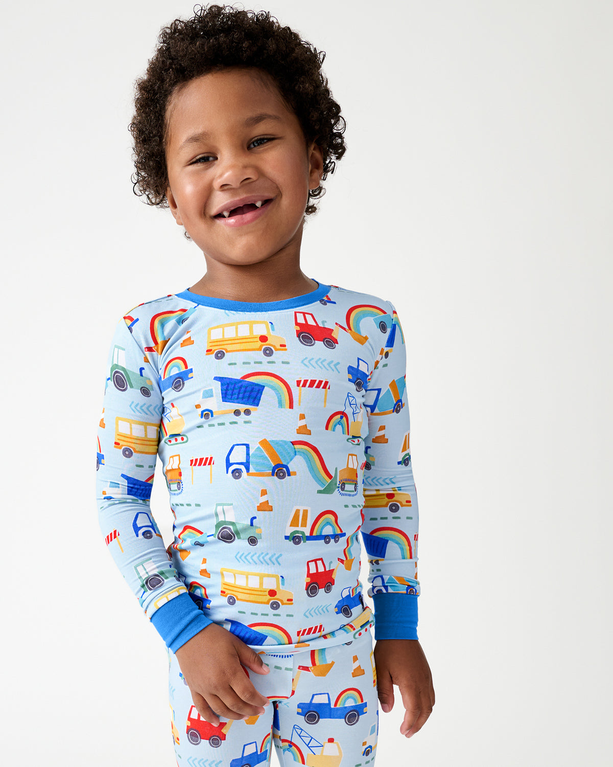 Close up of boy wearing the Rainbow Trucks Two-Piece Pajama Set