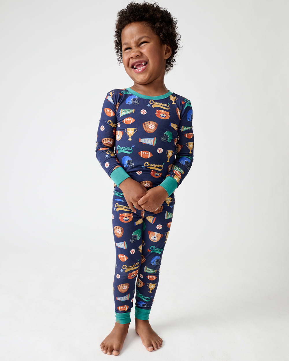 Standing boy wearing the Team Spirit Two-Piece Pajama Set