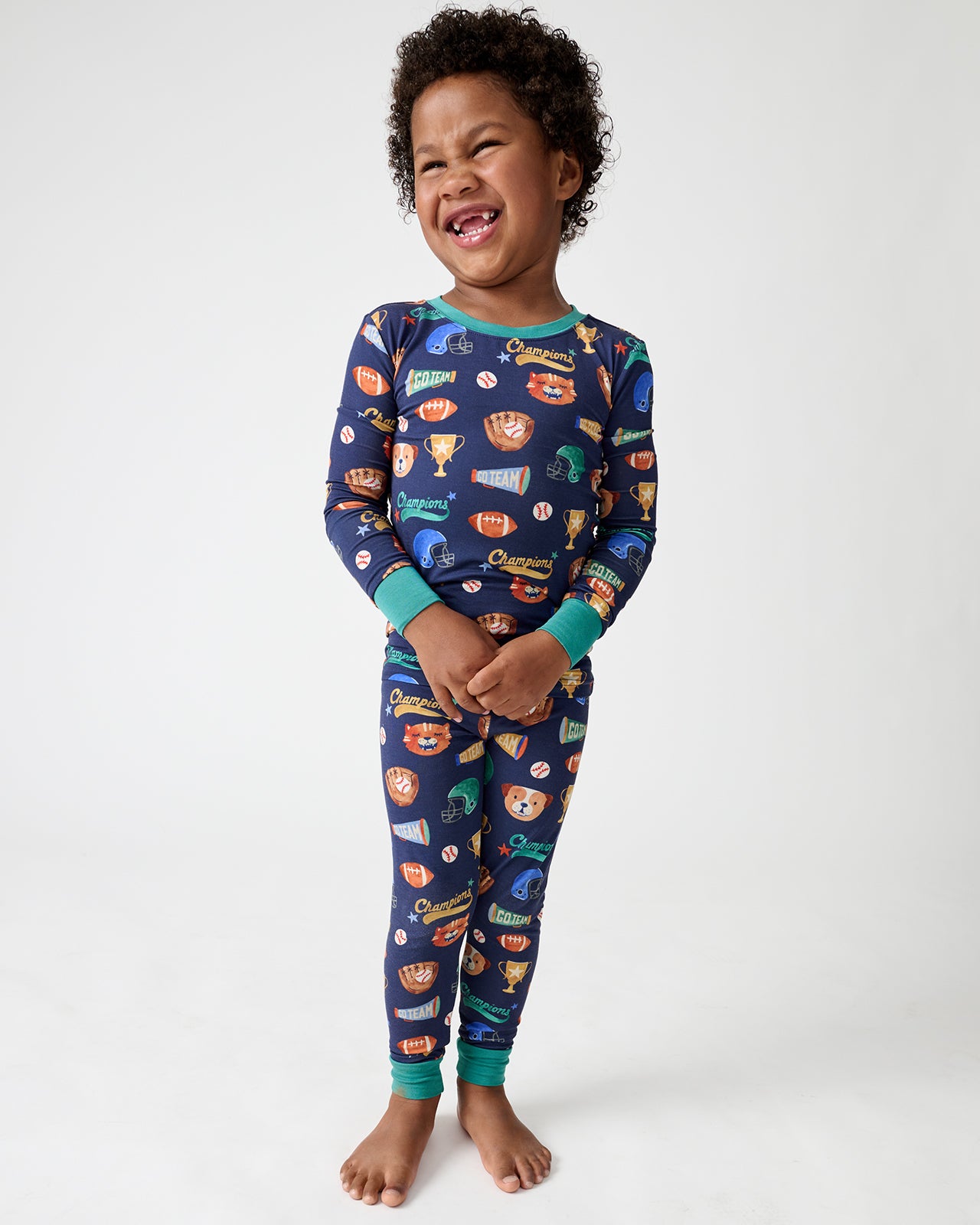 Standing boy wearing the Team Spirit Two-Piece Pajama Set