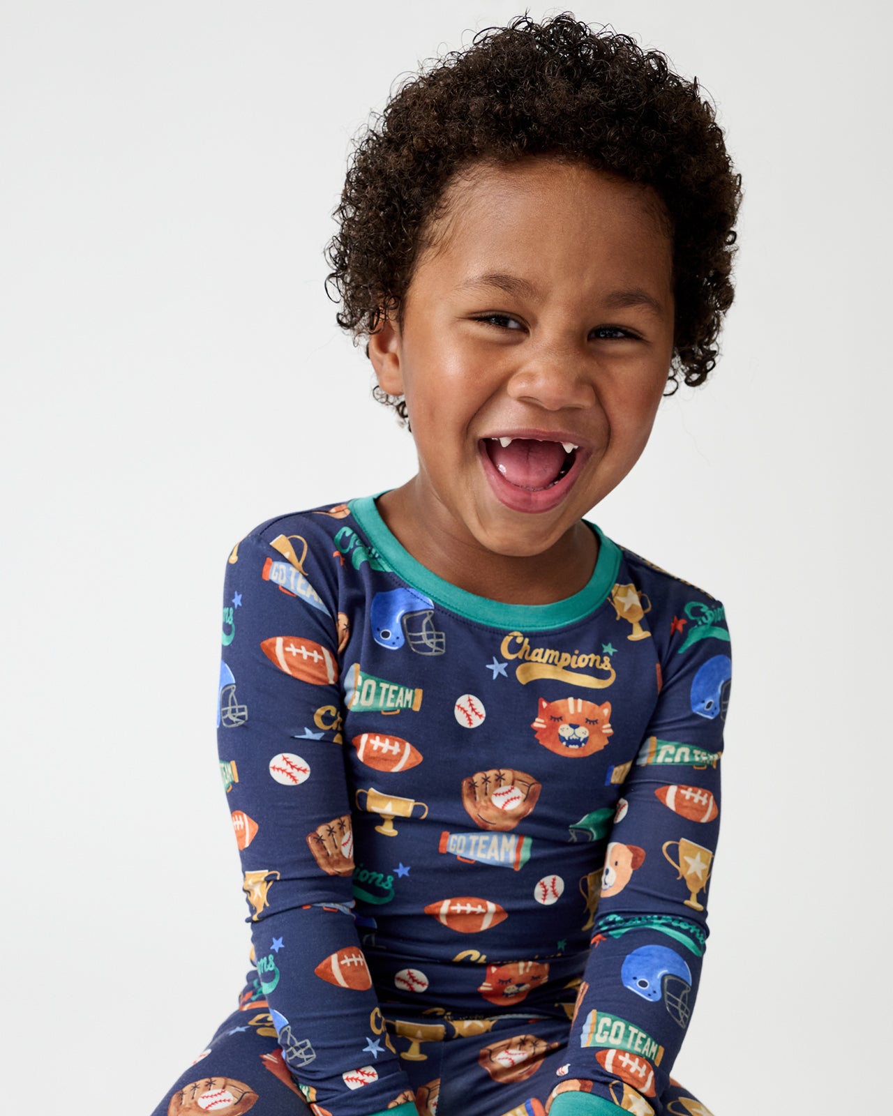 Close up of boy wearing the Team Spirit Two-Piece Pajama Set