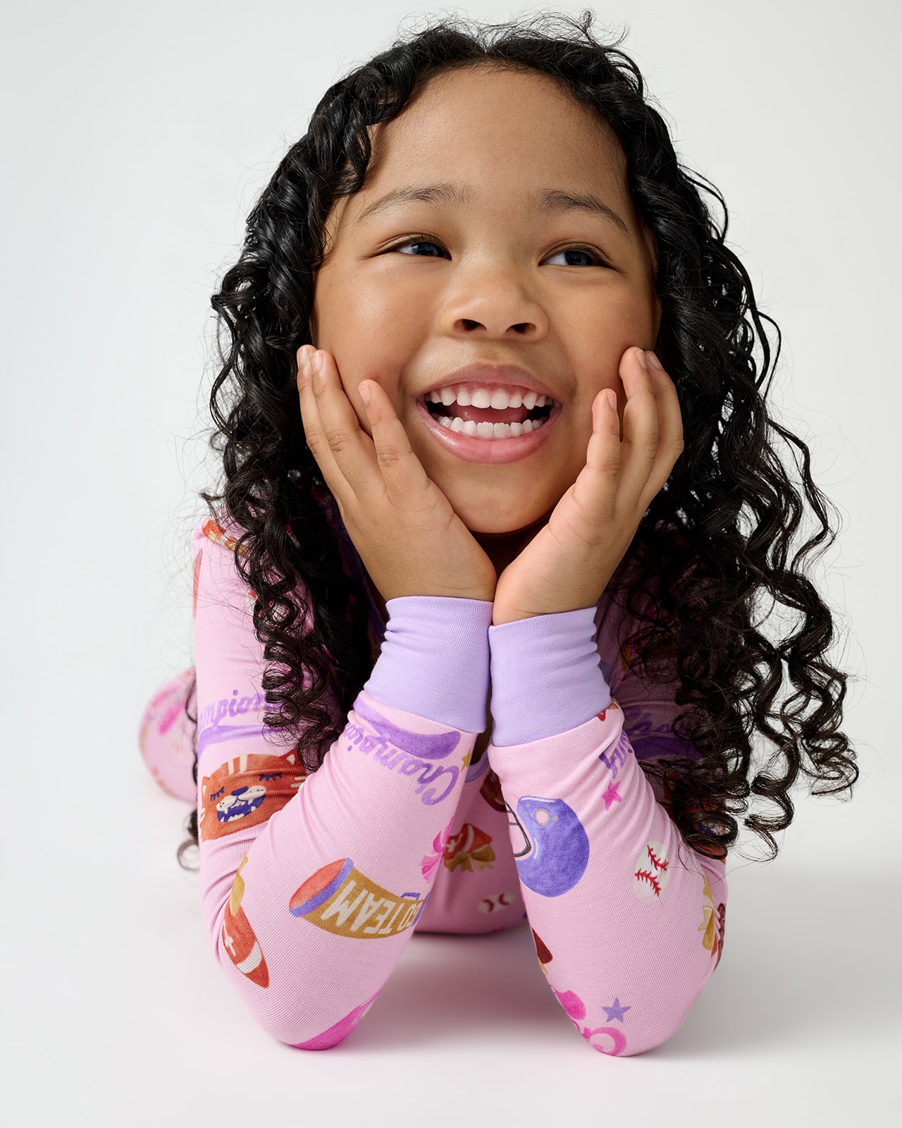 Close up of girl wearing the Team Spirit Pink Two-Piece Pajama Set