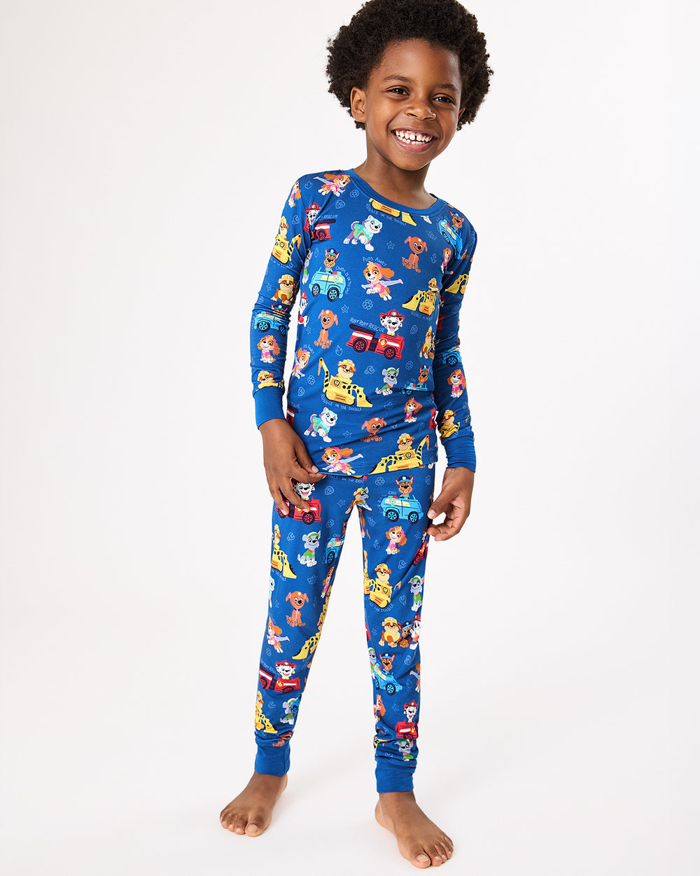 Standing boy wearing the PAW Patrol Adventure Bay Heroes Two-Piece Pajama Set