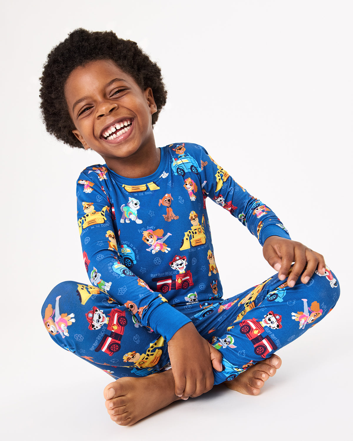 Sitting child wearing the PAW Patrol Adventure Bay Heroes Two-Piece Pajama Set