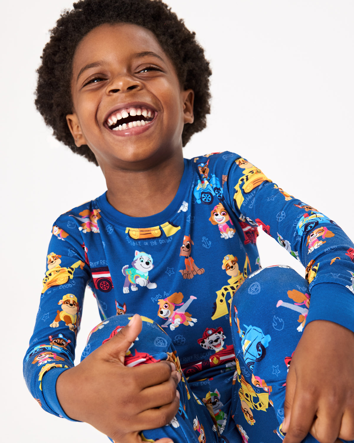 Close up of boy wearing the PAW Patrol Adventure Bay Heroes Two-Piece Pajama Set