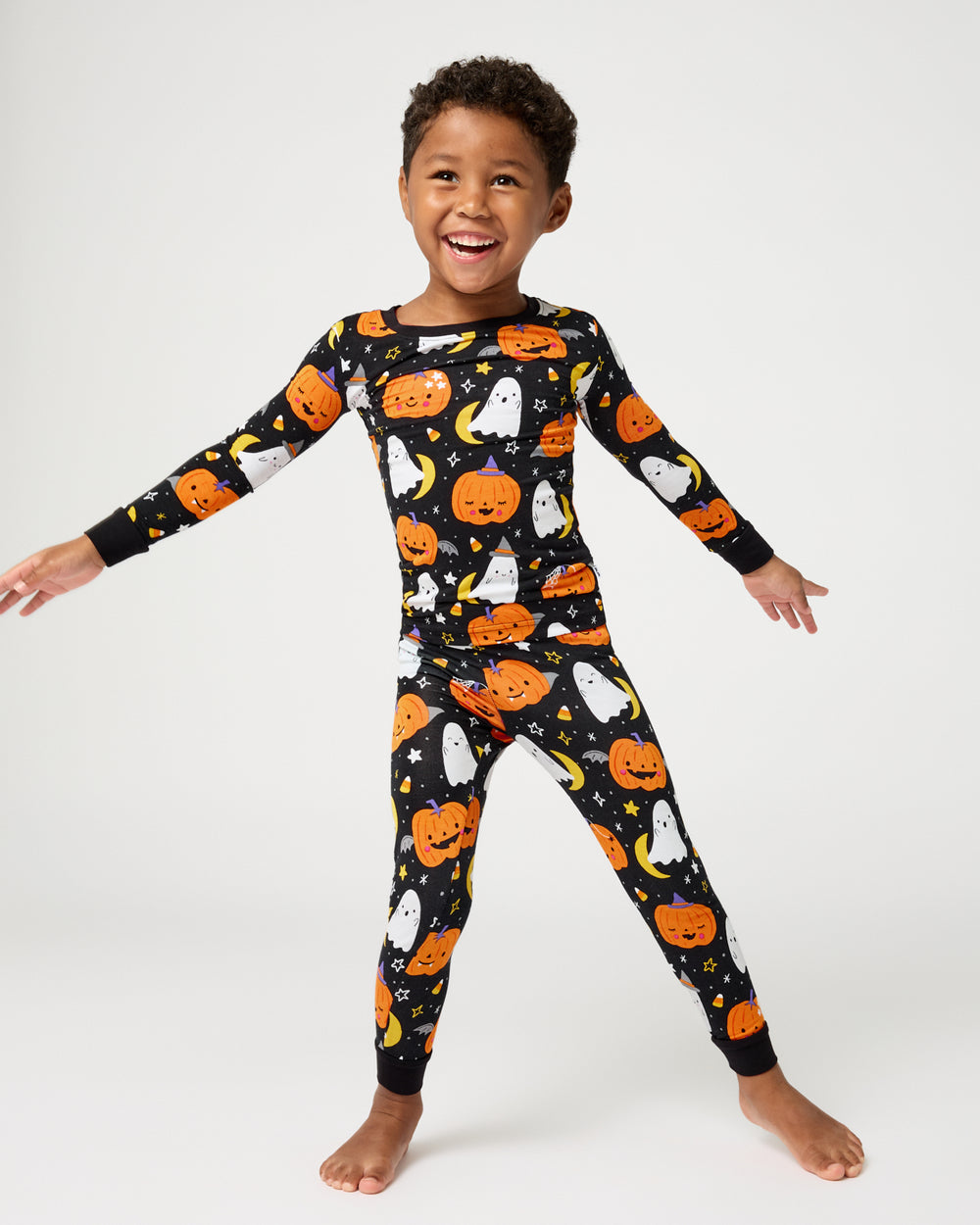 Standing child wearing the Moonlit Magic Two-Piece Pajama Set