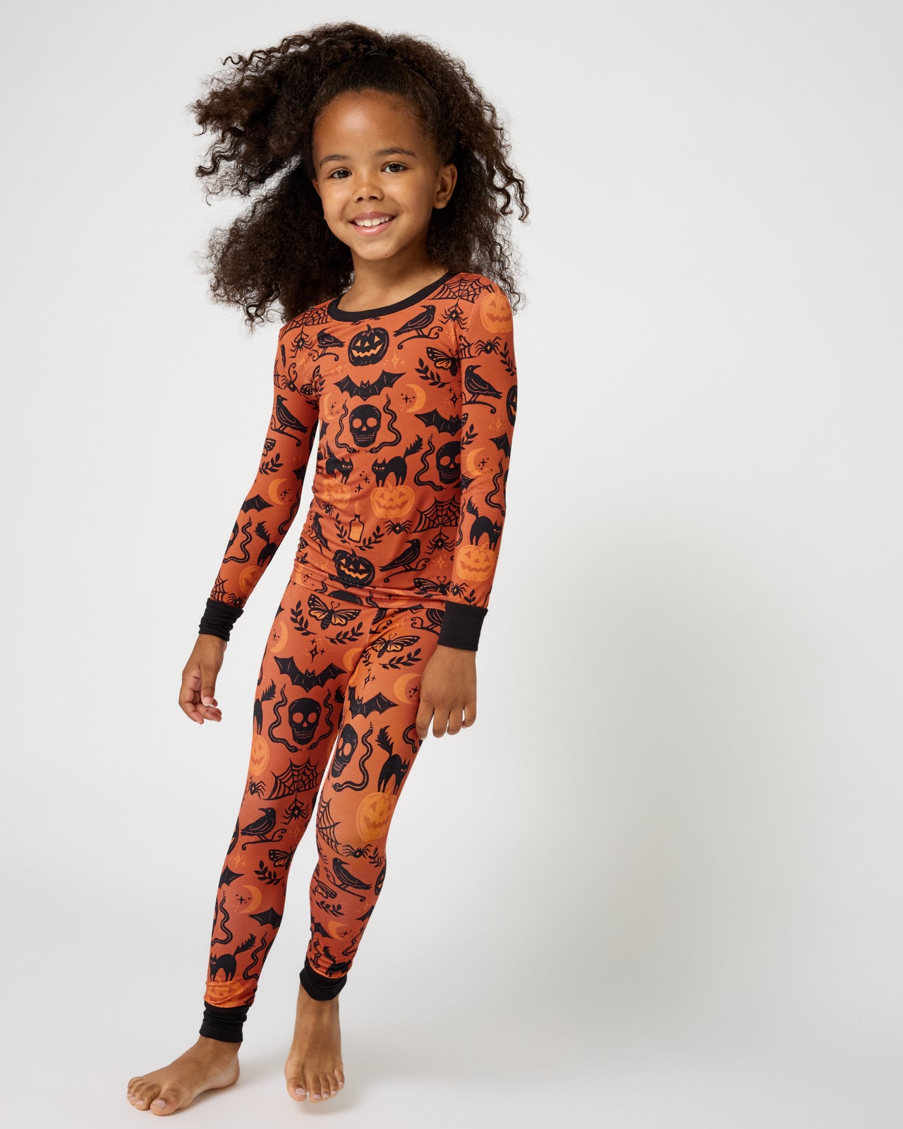 Standing girl wearing the Midnight Mischief Two-Piece Pajama Set