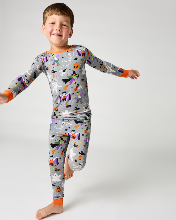 Boy wearing the Dracula's Disco Two-Piece Long Sleeve Halloween Pajama Set