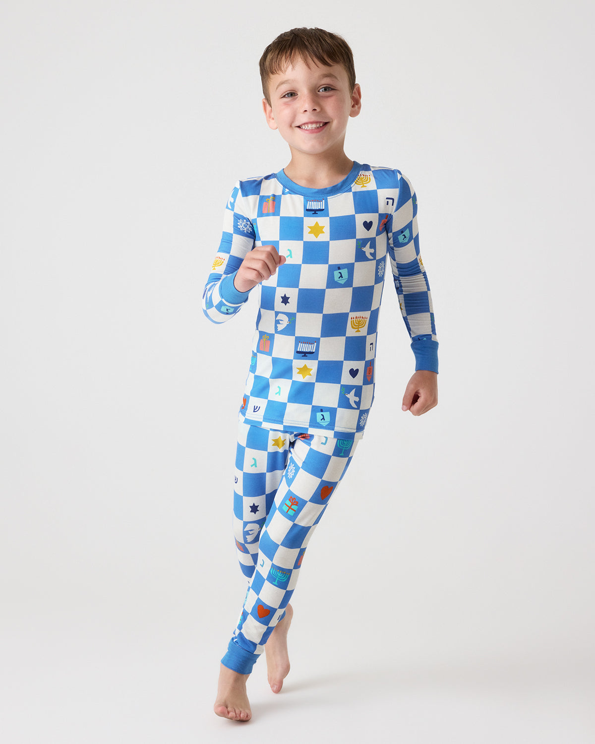 Running boy wearing the Hanukkah Checks Two-Piece Pajama Set