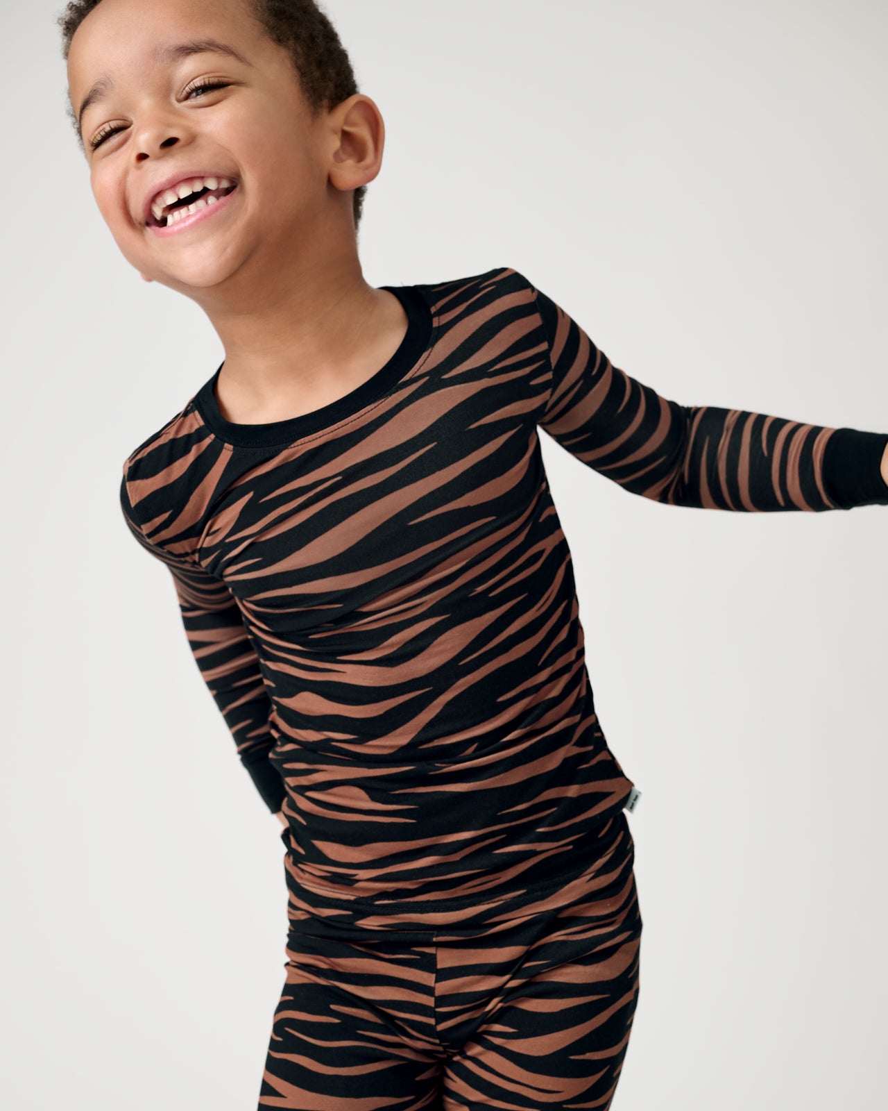 Close up of boy wearing the Wild Stripes Two-Piece Pajama Set