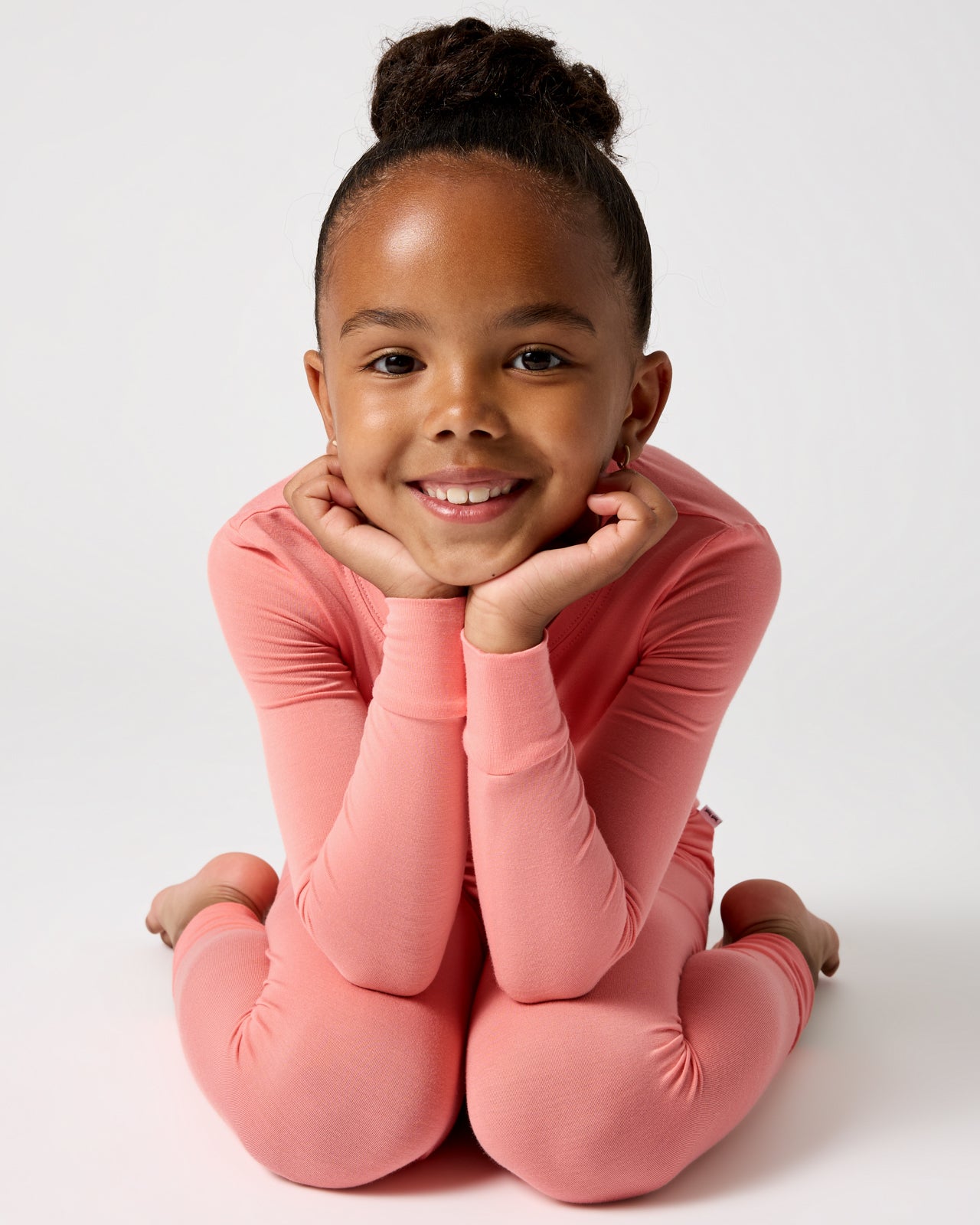 Posing child wearing the Sweet Papaya Two-Piece Pajama Set