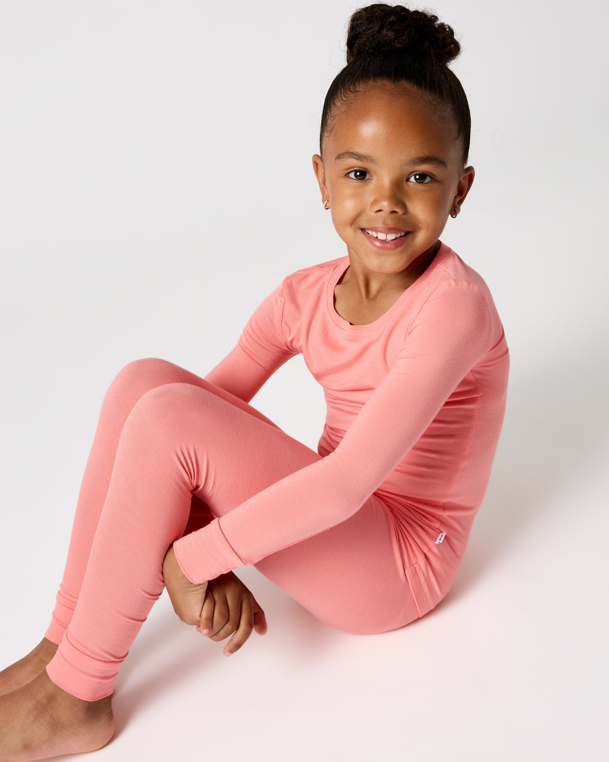 Sitting girl wearing the Sweet Papaya Two-Piece Pajama Set