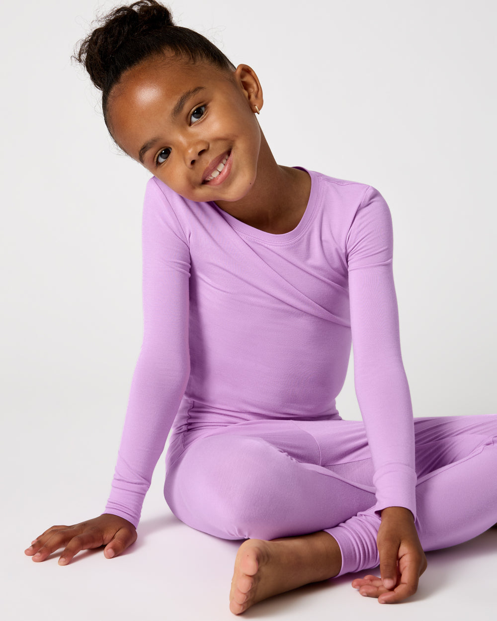 Sitting child wearing the Soft Wisteria Two-Piece Pajama Set