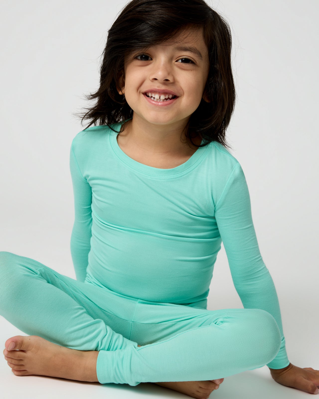 Sitting boy wearing the Ocean Mist Two-Piece Pajama Set