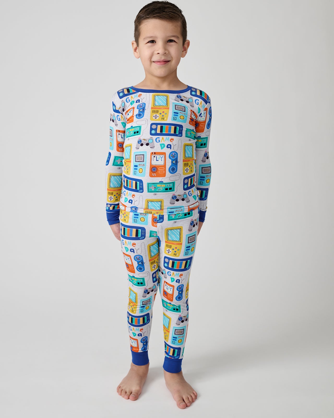 Standing boy wearing the Game On Two-Piece Pajama Set